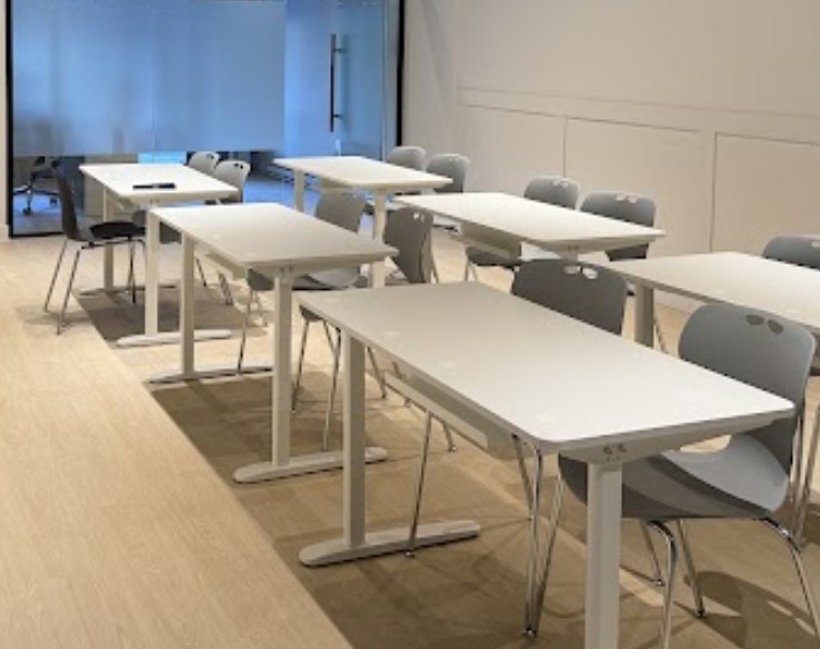 Desks set for a shared private class at Keats, where students work through their school homework